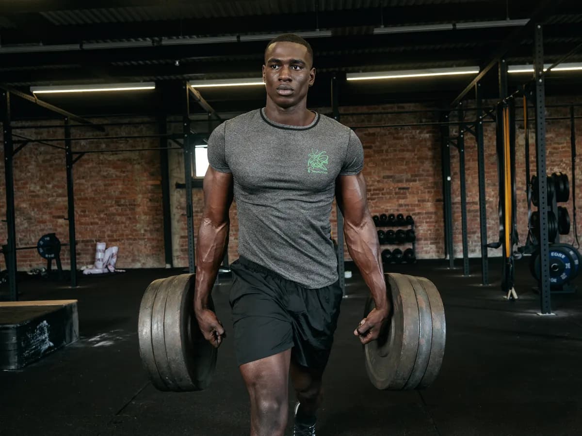 Athlete performing a loaded farmer carry